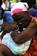 A Haitian woman clutches her rosary beads as an injured family member awaits treatment at the Killick Haitian Coast Guard Clinic.