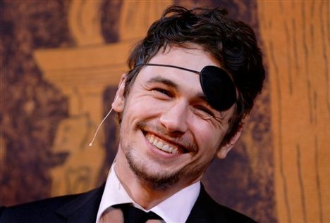 Actor James Franco, center, smiles as he is honored as Harvard University's Hasty Pudding Theatricals Man of the Year in Cambridge, Mass., Friday Feb. 13, 2009.