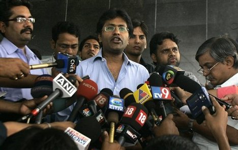 Indian Premier League (IPL) commissioner Lalit Modi, center, addresses the media after IPL board meeting for re-scheduling the tournament, in Mumbai, India, Friday, March 6, 2009