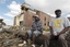 Sal Merritt, left, and Edrich Barnes rest outside the remains of Alberta Baptist Church in Tuscaloosa, Ala., on Thursday, April 28, 2011. The church was badly damaged by a tornado that left a path of destruction hundreds of yards wide.