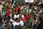 Palestinian Hamas security personnel and foreigners carry the coffin of Italian activist Vittorio Arrigoni during a "state funeral" in Gaza City on April 18, 2011 before the transferring of his body to Egypt via the Rafah border crossing in route to Italy where he will be buried. Arrigoni was found hanged in an abandoned house in the north of the Gaza Strip on March 14, hours after he was kidnapped by a fringe, radical Salafist group. (Photo By Ahmed Deeb/WN)