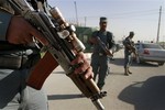 Afghan police officers stand guard at a check point following death of Al-Qaida leader Osama bin Laden, in Kabul, Afghanistan Tuesday, May 3, 2011.