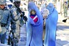 File - U.S. Navy Petty Officer 3rd Class Isaiah Wallace, second from left, with the Kunar Provincial Reconstruction Team security force, stands guard outside the Asadabad hospital in Kunar province, Afghanistan, Dec. 13, 2010.