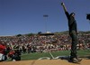 Adam Lambert, a finalist on the singing competition series, "American Idol," waves to fans during a visit to his alma mater, Mt. Carmel High School in San Diego on Friday, May 8, 2009. Lambert, who is one of three finalists on the show, is visiting locations in his home.