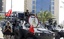 Bahraini soldiers secure the area atop their armored vehicles decorated with national flags along a picture of Bahrain's King Hamad bin Isa Al Khalifa near the Pearl Square in Manama, Bahrain, Saturday, March 19, 2011. Bahrain tore down the 300-foot (90-meter) monument at the heart of a square purged of Shiite protesters this week, erasing a symbol of an uprising that's inflaming sectarian tensions across the region.