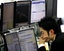 A money trader at a Tokyo dealing room reacts as U.S. dollar is traded below 90 yen level Friday afternoon, Dec. 12, 2008. The dollar's fall to a 13-year-low against the yen also accelerated selling on the Tokyo Stock Exchange, hitting hard exporters such as autos and electronics. The greenback fell as far as 88.16 yen in the afternoon, its lowest level since Aug. 2, 1995 when the U.S. currency fell to 88.02 yen while the Nikkei average lost 484.68 points, or 5.56 percent, to close at 8,235.8