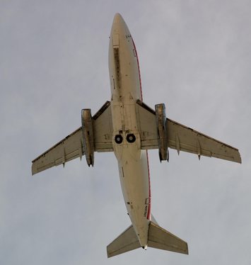 Boeing 737-200 Adv planform and exposed landing gear tires are visible on this USAF T-43 takeoff