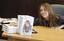 Singer and actress Miley Cyrus hands her book 