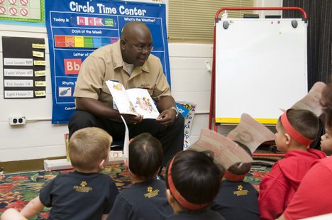 Yeoman 1st Class Calvin Everett reads to students at Lehua Elementary School.