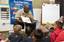 Yeoman 1st Class Calvin Everett reads to students at Lehua Elementary School.