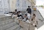 Tribesmen take positions next to the house of Sheik Sadeq al-Ahmar, the head of the powerful Hashid tribe, during clashes with Yemeni security forces in Sanaa, Yemen, Tuesday, May 24, 2011.