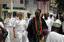 A delegation of Naval Commanding Officers representing Navies from around the world, are led in procession behind the Obo of Lagos Nigeria by Commander, Destroyer Squadron Six Zero (COMDESRON-60), Commodore Tom Rowden.