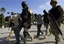 Mexican Army soldiers hold two suspects, arrested during an operation against drug smuggling and kidnapping gangs, after being presented to the press in Tijuana, Mexico, Wednesday, Dec. 3, 2008.