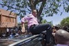 Presidential candidate Michel Martelly climbs a vehicle to address supporters after voting a presidential runoff in Petion Ville, Port-au-Prince, Haiti, Sunday, March 20, 2011.