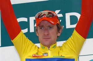 Bradley Wiggins of Britain celebrates on the podium as he keeps the overall leader´s jersey after the 1th stage of the Dauphine Libere cycling race between Grenoble and Roanne, central France, Monday, June 11, 2007.