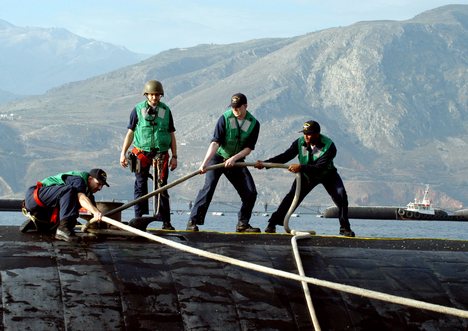 Sailors handle mooring lines as the Los Angeles-class attack submarine USS San Juan (SSN 751) arrives for a port visit.