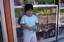 A fat child holding a jar of chocolates in front of a store in Cavite, Philippines