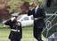 President Barack Obama returns a salute as he returns to the White House in Washington, Friday, April 15, 2011, after a trip to Chicago.