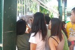 Filipina women looks at the official Comelec registration to vote in the national and local election of the country ,Quezon City , Philippines ,  May 10 , 2010.