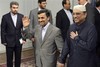 Iranian President Mahmoud Ahmadinejad, center, and his Pakistani counterpart Asif Ali Zardari, right, arrive for a meeting, at the Iranian presidency office in Tehran, Iran, Friday, June 24, 2011.