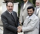 File - Iranian President Mahmoud Ahmadinejad, right, shakes hands with Iraqi Prime Minister Nouri Al-Maliki, duing an official welcoming ceremony for him, in Tehran, Iran, Tuesday, Sept. 12, 2006.