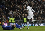 Real Madrid's Emmanuel Adebayor from Togo, right, celebrates after scoring pass Sevilla's goalkeeper Javier Varas, left, during their Copa del Rey semifinal second leg at the Santiago Bernabeu stadium on, Wednesday, Feb. 2, 2011 in Madrid.