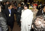 Libya's leader Moammar Gaddafi, center, arrives at UN Conference Hall in Addis Ababa, Ethiopia, Sunday, Jan. 31, 2010, for the 14th Ordinary Session of the Assembly of the African Union.