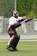 A goalkeeper makes a glove save. Equipment worn here is typical gear for a goalkeeper.