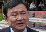 Former Thai Prime Minister Thaksin Shinawatra talks to members of the press in Podgorica, Montenegro, Monday, April 26, 2010.