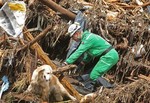 A policeman with a search dog looks for victims among landslide debris in Santo Antonio, a village outside Funchal, the Madeira Island's capital, Monday, Feb. 22 2010. Several houses in the village were wrecked by a landslide Saturday when heavy rain hit the Portuguese island. The local government has confirmed the heavy rains have claimed over 40 lives.