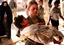 File - A Soldier carries a wounded Iraqi child into the Charlie Medical Centre at Camp Ramadi, Iraq, 20th of March, 2007.