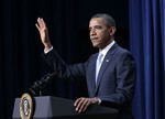 President Barack Obama gestures as he hosts military fathers and their children for a screening of Disney/Pixar movie 'Cars 2' in the South Court Auditorium of the Eisenhower Executive Office Building on the White House complex, Wednesday, June 15, 2011.