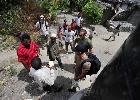 Members of Maritime Civil Affairs Team (MCAT) 115 assess the placement of a 5,000-liter water cistern with residents of Fundo Island, a small islet that is part of Pemba Island.