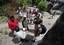 Members of Maritime Civil Affairs Team (MCAT) 115 assess the placement of a 5,000-liter water cistern with residents of Fundo Island, a small islet that is part of Pemba Island.