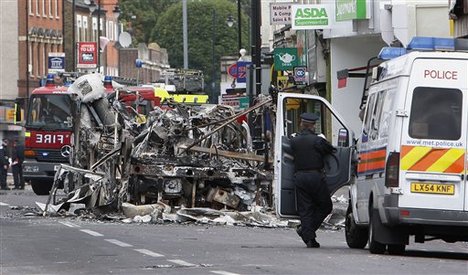 A burned bus is seen in Tottenham, north London, Sunday, Aug. 7, 2011 after a demonstration against the death of a local man turned violent and cars and shops were set ablaze.