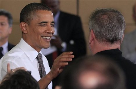 President Barack Obama pats a worker on the shoulder during a visit to the American Cord & Webbing Co. in Woonsocket, R.I., Monday, Oct. 25, 2010. Obama touted his administration's support for small business a week from the elections, and said Republicans claim to be on the side of the middle class, but fail to support help for small businesses and others.