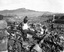 Battered religious figures stand watch on a hill above a tattered valley, Nagasaki, Japan. September 24, 1945.