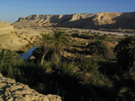 Desert landscape in Oman. A vast gravel desert plain covers most of central Oman, with mountain ranges along the north (al Jebel al Akhdar) and southeast coast, where the country's main cities are also located: the capital city Muscat, Matrah and Sur in the north, and Salalah in the south.