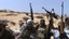 In this image made from amateur video and accessed by The Associated Press on Friday, Aug. 12, 2011, rebel soldiers celebrate in Brega, Libya, Thursday, Aug. 12, 2011.