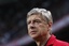 Arsenal coach Arsene Wenger watches his players during their soccer match against Ajax