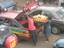 A woman loads loaves of Bread unto a Taxi in Freetown.