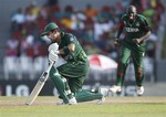 Pakistan's batsman Kamran Akmal reacts after being dismissed as Kenyan bowler Shem Ngoche, back, celebrates during the ICC Cricket World Cup match between Kenya and Pakistan in Hambantota, Sri Lanka, Wednesday, Feb. 23, 2011.