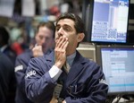 Specialist Peter Mazza, right, works on the floor of the New York Stock Exchange, Tuesday, Sept. 30,