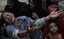 Family members of a target killing victim mourn his death in Karachi, Pakistan on Wednesday, Aug. 17, 2011.