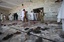 Pakistani villagers clean the floor of a mosque targeted by a suicide attacker in Ghundi, in the Pakistani tribal area of Khyber, Friday, Aug. 19, 2011.