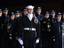 A Sailor assigned to the Ceremonial Honor Guard, along with members of the United States Air Force band stands at the ready as the casket of Gerald R. Ford, arrives in Washington, DC