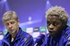 Arsenal player Alex Song, right, speaks during a press conference with Arsenal coach France's Arsene Wenger, at the Partizan Stadium in Belgrade, Serbia, Monday, Sept. 27, 2010. Arsenal will play against Partizan Belgrade in a UEFA Champions League match in Belgrade on Tuesday evening.