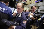 Traders Michael Urkonis, left, and Jonathan Corpina work on the floor of the New York Stock Exchange Wednesday, Oct. 27, 2010.