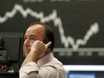 A broker is seen under the curve of the German stock index DAX at the stock market in Frankfurt, central Germany, Thursday, Dec. 4, 2008. Europe's stock markets rose modestly Thursday after Wall Street recovered most of its earlier losses, but investors remained cautious after big interest rate cuts in Europe and ahead of Friday's crucial U.S. jobs report for Novem