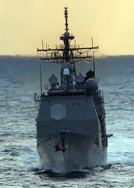 The guided missile cruiser USS Vella Gulf (CG 72) maneuvers aft of the nuclear powered aircraft carrier USS George Washington (CVN 73).